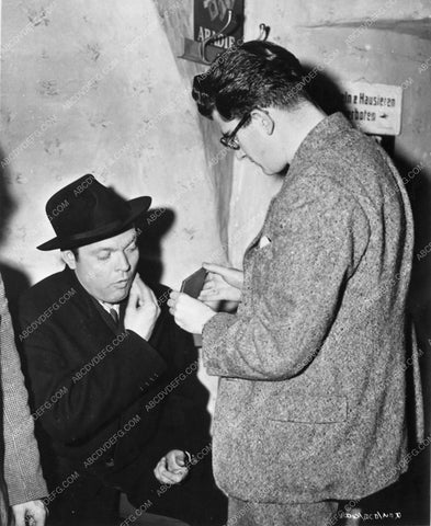 Orson Welles doing last minute makeup check behind the scenes 4739-08