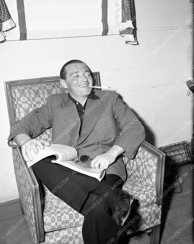 candid Peter Lorre relaxes while going over the script 4b09-035