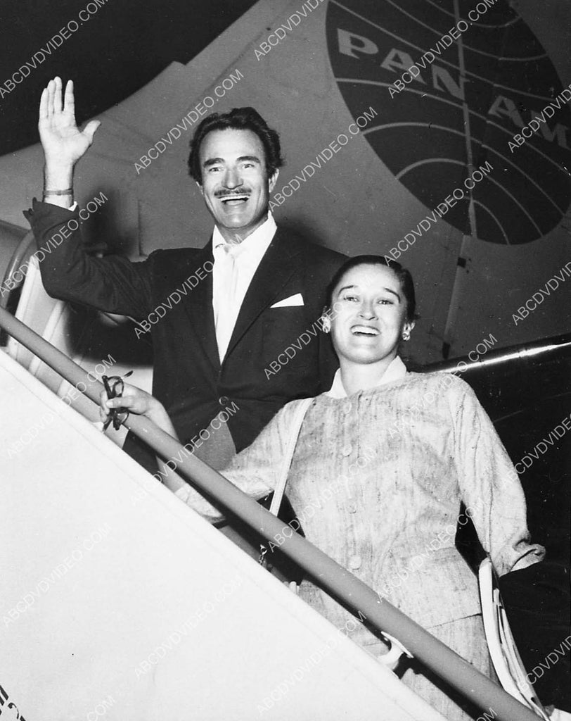 Gilbert Roland and his wife getting on Pan Am airplane 6244-17 ...