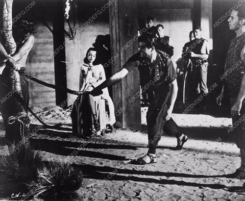 Ron Randell whipping some guy film Captive Women 6507-32