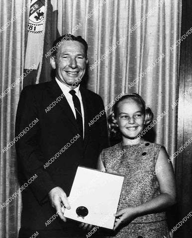 Los Angeles mayor Sam Yorty gives some girl a merit award or something 7022-033