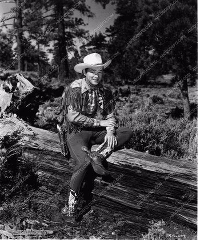 Roy Rogers sitting on log 7763a-21