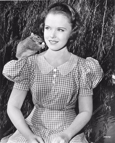 Gloria Jean entertains a squirrel on her shoulder 81bx01-058