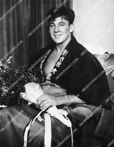 candid George O'Brien in his kimono robe w some flowers 8213-16