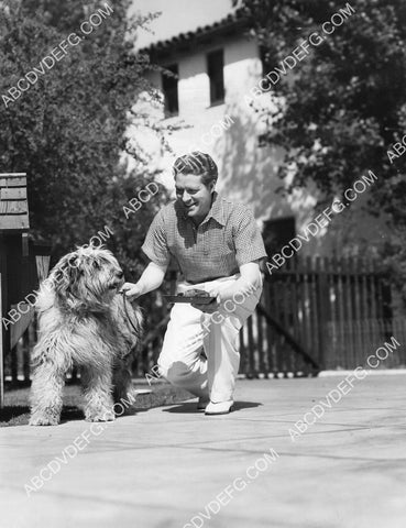 Nelson Eddy at home playing w his dog 8B11-751