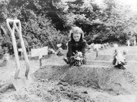 WWII D-Day plus 6 French girl puts flowers on U.S. soldier's grave 8B11-817