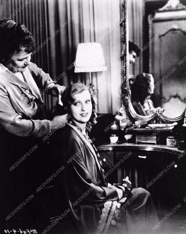 Jeanette MacDonald gets her hair brushed MGM Studios 8b03-802