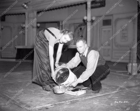 Ida Lupino helps crew member get set ready One Rainy Afternoon 8b4-395