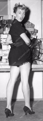 Pat Hall in short skirt in front fan wraps Christmas packages 8b6-101