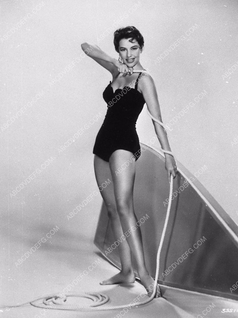 Cyd Charisse measuring a length of rope in her swimsuit 9202 13