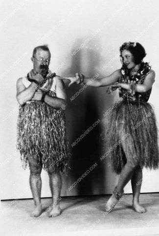 Sally Blane teaching how to dance in grass skirt 9223-07