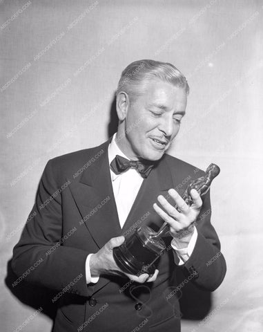 1947 Oscars Ronald Colman admiring his statue Academy Awards aa1947-26</br>Los Angeles Newspaper press pit reprints from original 4x5 negatives for Academy Awards.