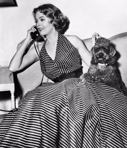 Arlene Dahl on the phone with her dog standing by 8b20-0041