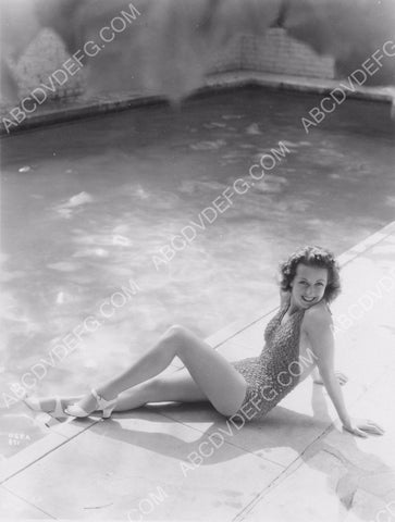 Danielle Darrieux in swimsuit sitting poolside 8b20-10544