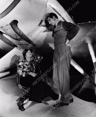 Cary Grant Myrna Loy sitting under an airplane 8b20-10591