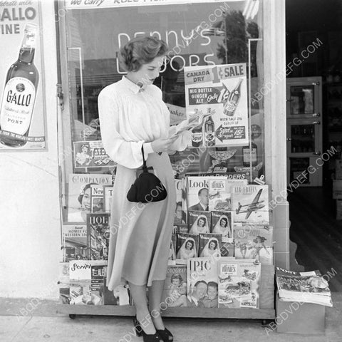 candid Colleen Townsend makes a selection at the magazine rack 8b20-10839