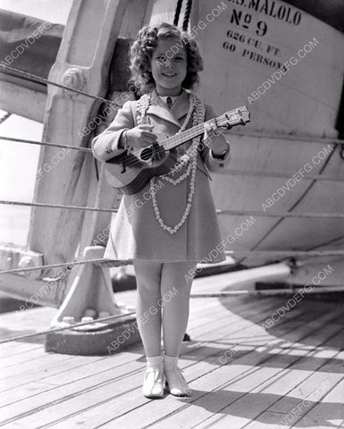 Shirley Temple plays ukulele on board a ship 8b20-1118