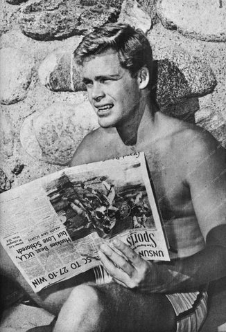 shirtless and athletic Doug McClure reading the sports section 8b20-11872