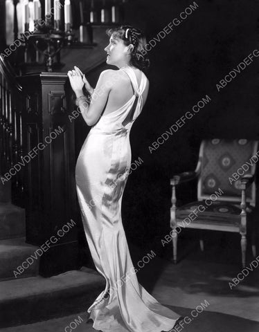 Gloria Swanson in white dress at foot of the stairs 8b20-12395