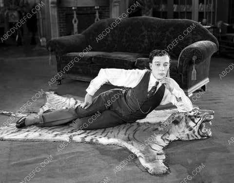 Buster Keaton laying on a tigerskin rug 8b20-14960