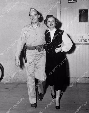 Barbara Stanwyck and serviceman on studio backlot soundstage 8b20-15532