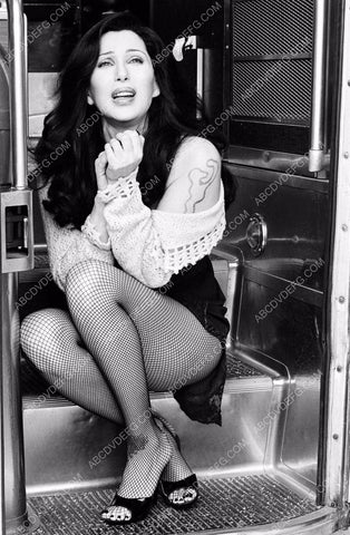 Cher sitting on the steps of the bus in her fishnets 8b20-16693