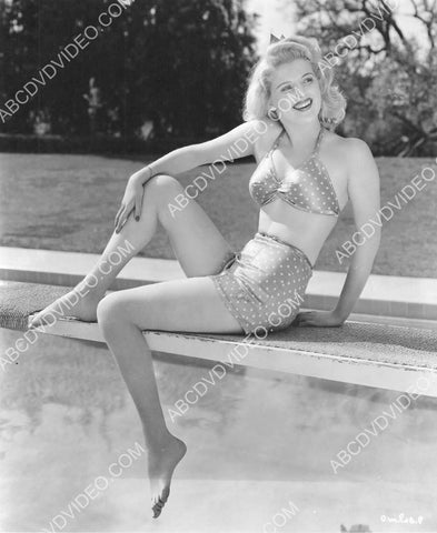 Dolores Moran in her bikini sitting on the diving board 8b20-17534