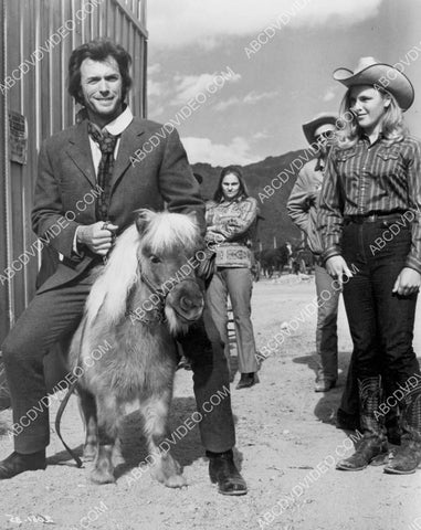 Clint Eastwood clowning around sitting on a pony 8b20-17970