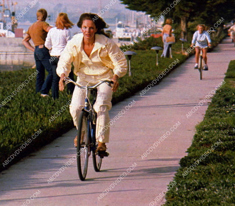 Jaclyn Smith racing her bicycle down the boardwalk 8b20-18503