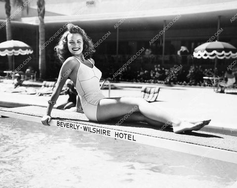 Janet Blair sitting on the diving board at The Beverly Wilshire Hotel 8b20-18618