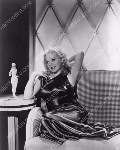 Alice Faye seated next to a small figurine 8b20-1899