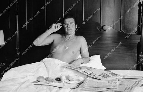 Roger Moore newspapers and breakfast in bed 8b20-20099