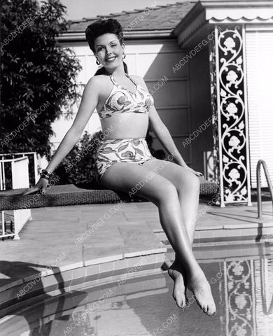 beautiful Ann Miller in bikini sitting on diving board by swimming pool dp-2379