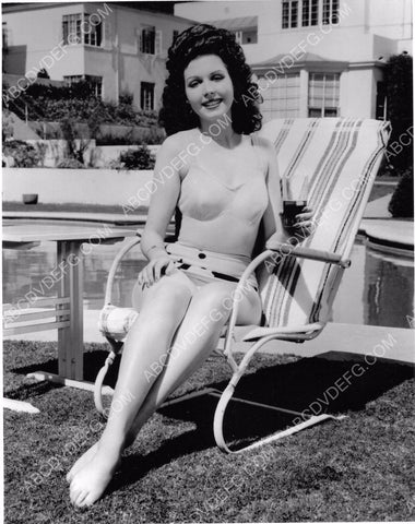 Ann Miller enjoys a glass of ice tea by the swimming pool dp-2381