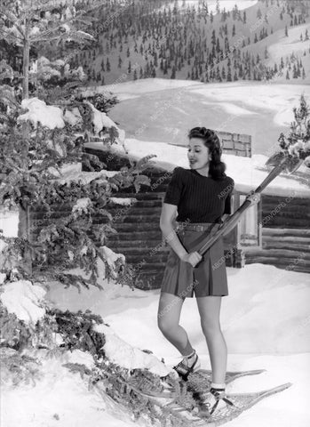 Ann Rutherford in snow shoes chopping down own Christmas Tree 8b20-2409