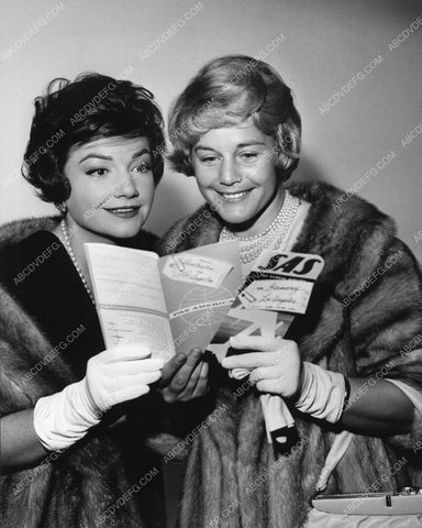 Anne Baxter and friend look at their Pan-Am plane tickets 8b20-2476