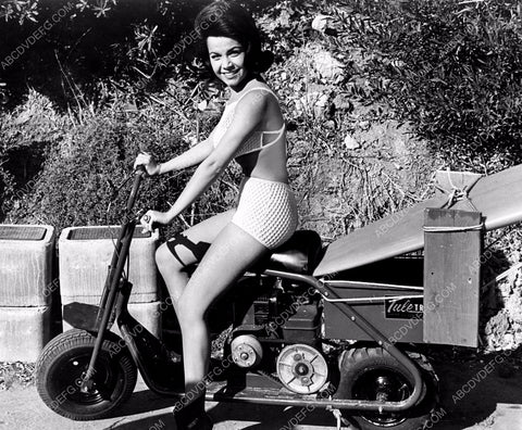 Annette Funicello tows her surfboard on cool motor scooter 8b20-2894