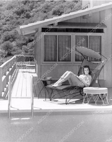 candid photo Barbara Rush lies on lounge by the pool does a little reading 8b20-3392