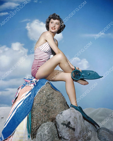 athletic Barbara Stanwyck putting on flippers and diving mask for swim 8b20-3516