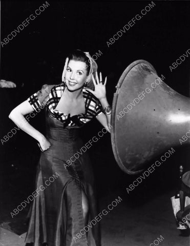 Ann Miller listens to giant speaker behind the scenes dp-4103