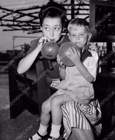 Anne Shirley and son maybe blowing up balloons at a carnival 8b20-4325