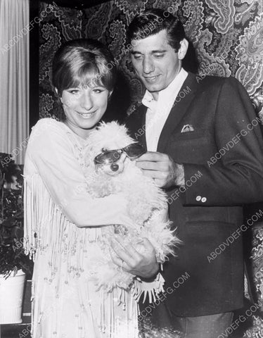 candid Barbra Streisand holds dog while Joe Namath put sunglasses on 8b20-4616