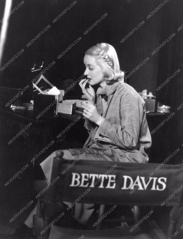 Bette Davis looks in mirror for quick makeup check 8b20-4746