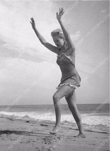 Betty Grable about to d a cart-wheel on the beach 8b20-4812