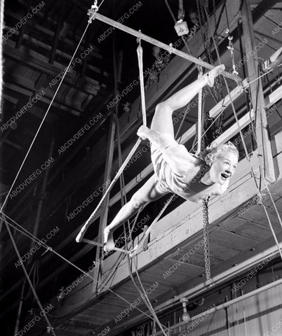 athletic Betty Hutton practices on circus trapeze swing 8b20-4921