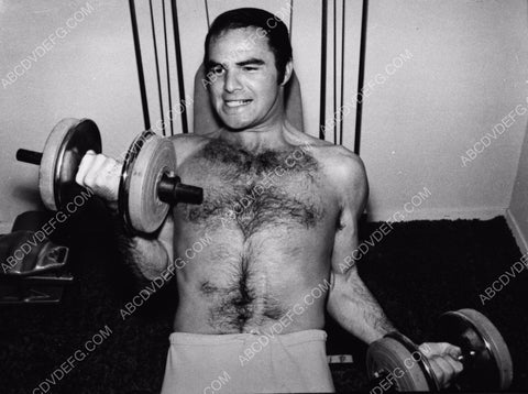 athletic Burt Reynolds lifting weights 8b20-5613