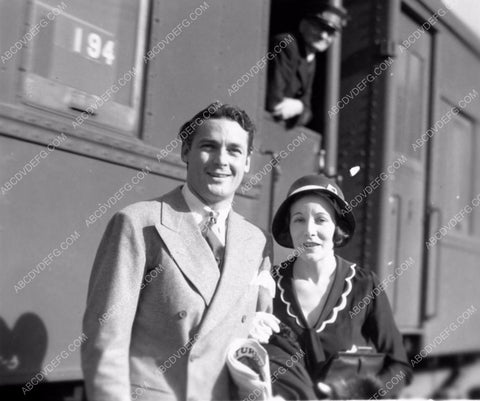 Charles Farrell and wife maybe getting off a train 8b20-7335