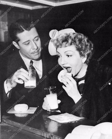 candid Don Ameche Claudette Colbert enjoy milk and donuts 8b20-7793