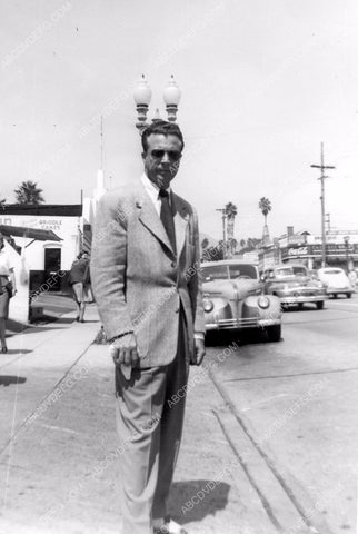 candid Dick Powell on the sidewalk of town 8b20-8185