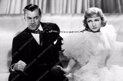 Claudette Colbert and Gary Cooper chained at the neck 8b20-8842